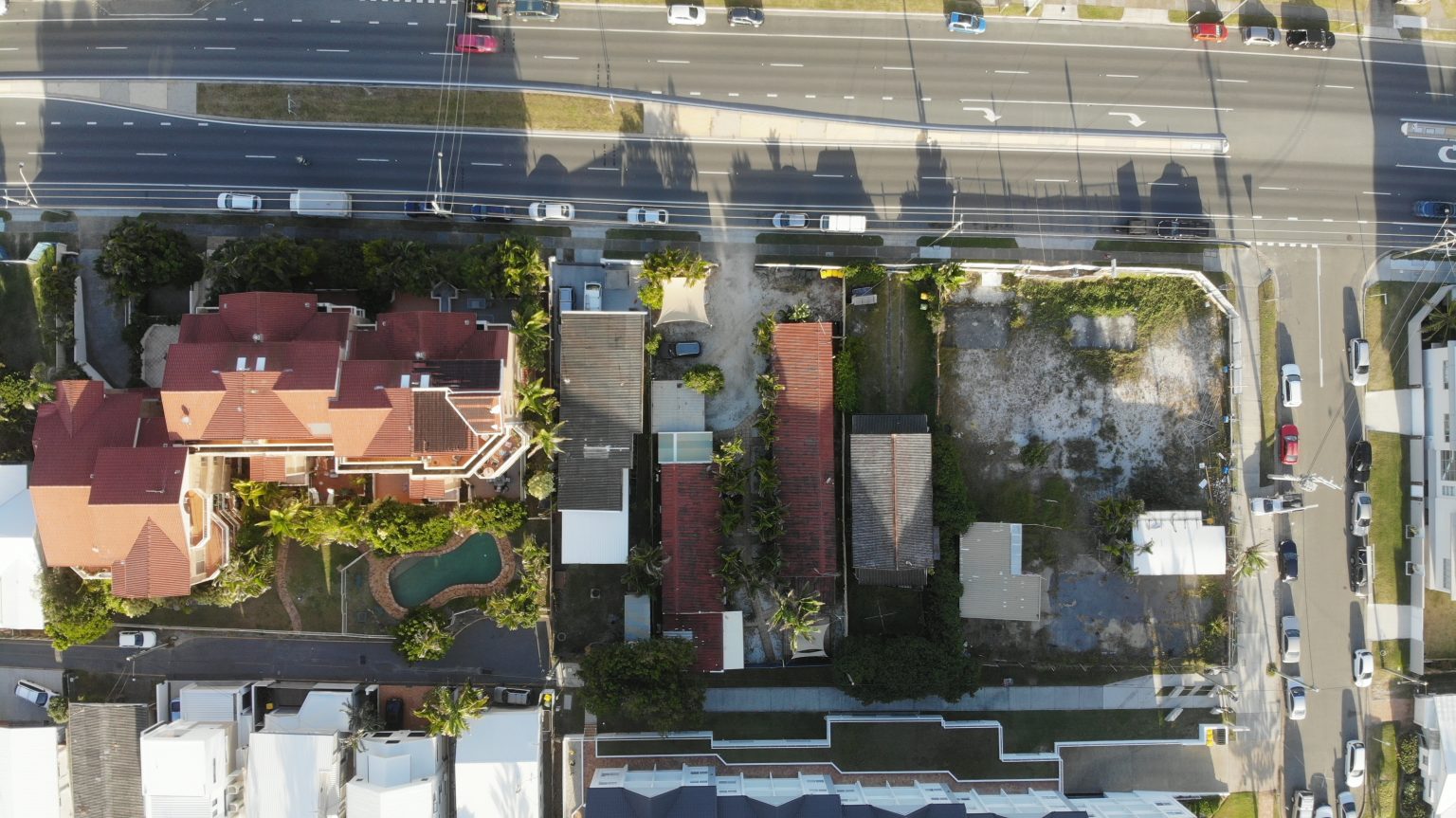 Aerial view over suburban properties and a vacant development site