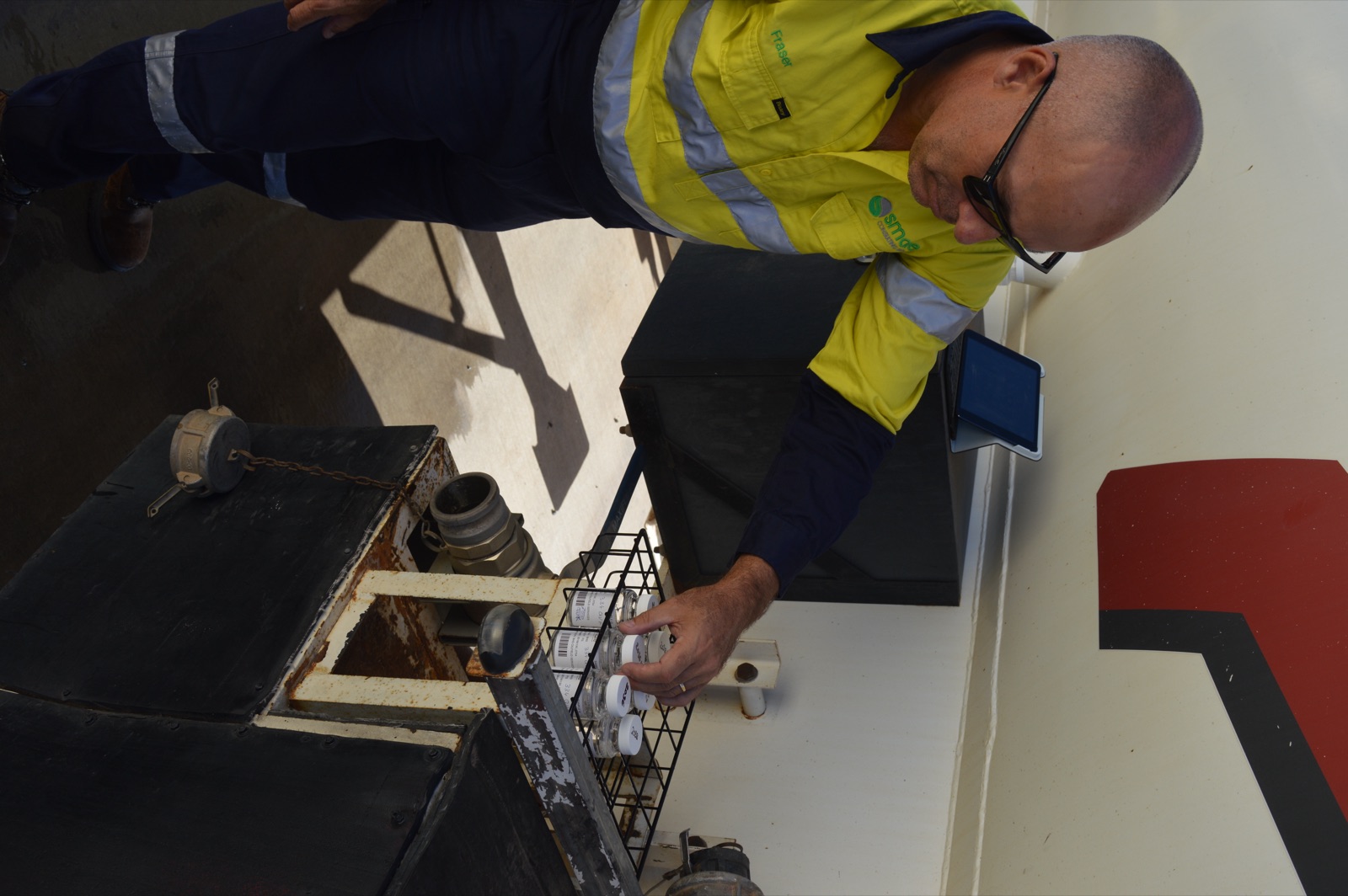 SCG consultant collecting potable water samples at a tanker sampling point